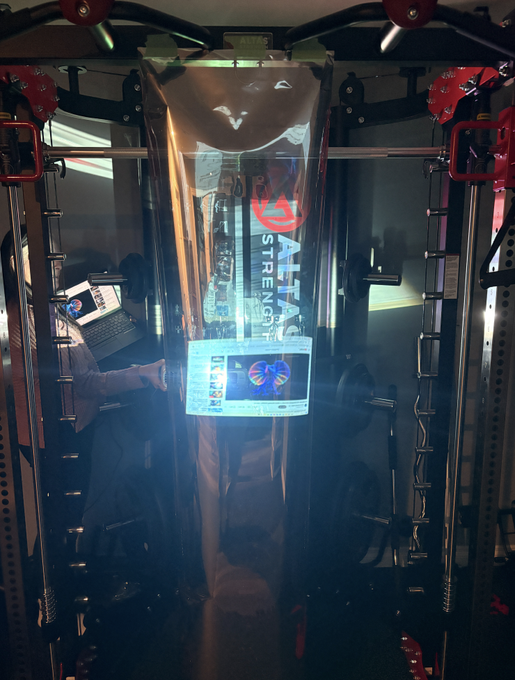 To explore a more viable solution, I tested combining plexiglass with the window film to create a DIY two-way mirror. I removed the plexiglass from an old picture frame and cut the film to match its size. After applying the film to the plexiglass, the surface began to resemble a functional mirror.

I then placed my iPad behind the plexiglass to act as a display. The video from the iPad was visible through the film while still allowing me to see my reflection. This experiment demonstrated that a two-way mirror effect could be achieved using plexiglass and window film, providing a more affordable solution for our final prototype.